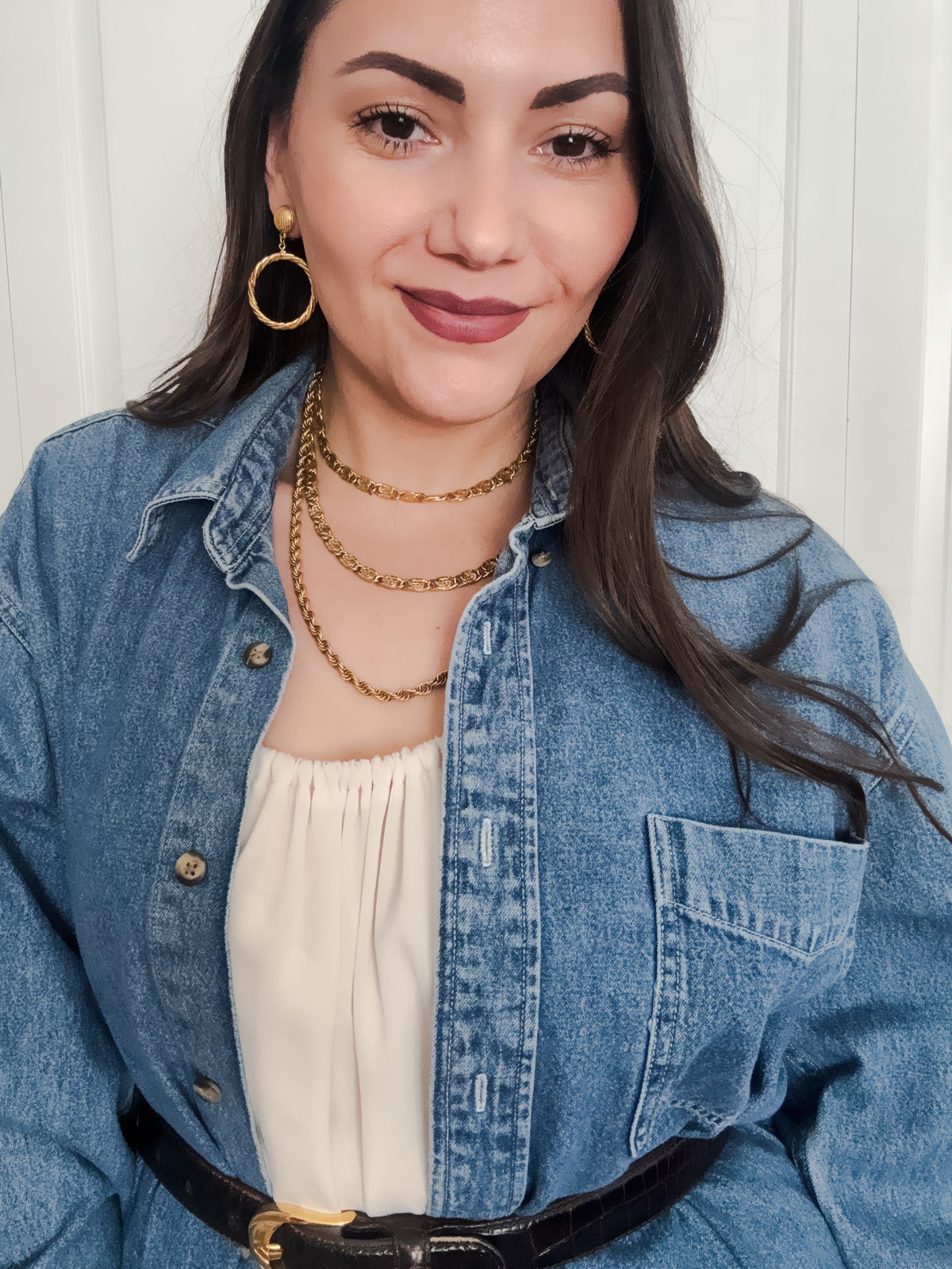 long gold double chain necklace in a layered effect styled with vintage denim
