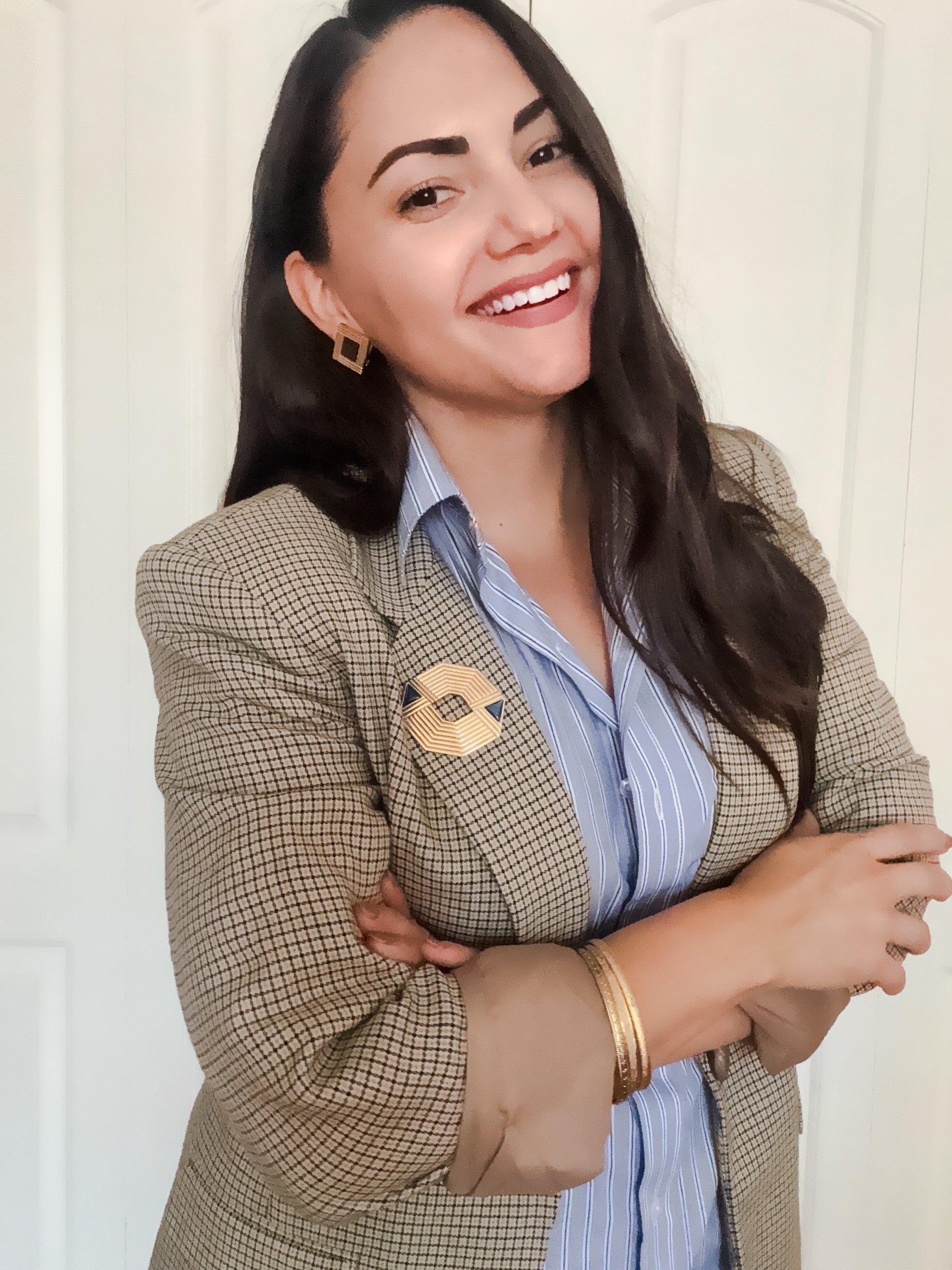 Gold geometric brooch and earrings styled with a vintage blazer and striped blouse. 