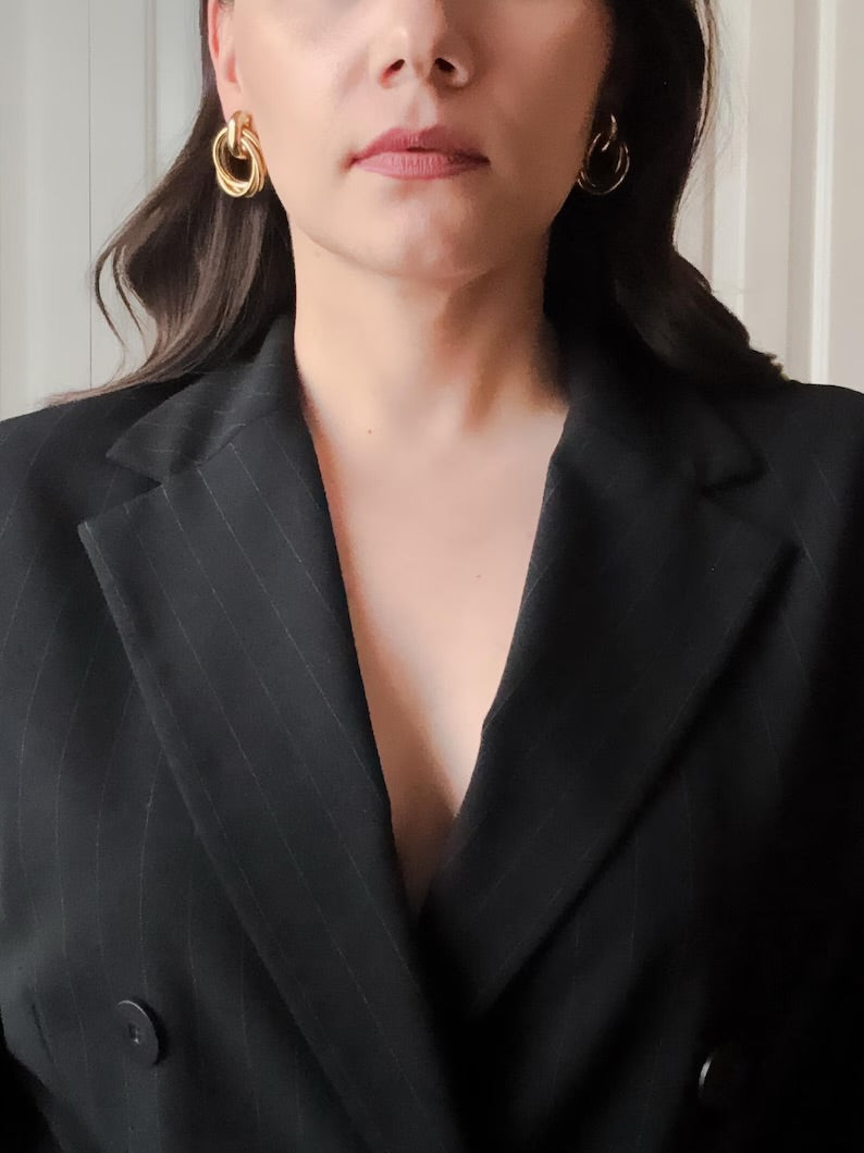 A model wearing the vintage 90s gold interlocking ring earrings
